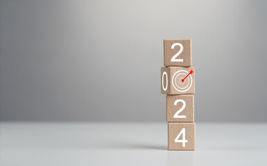 2024 Goals of business or life. Wooden cubes with 2024 and goal icon on smart background. Starting...