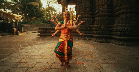 Portrait of Expressive Young Females Dancing Folk Dance Choreography in Temple. Indian Women in...