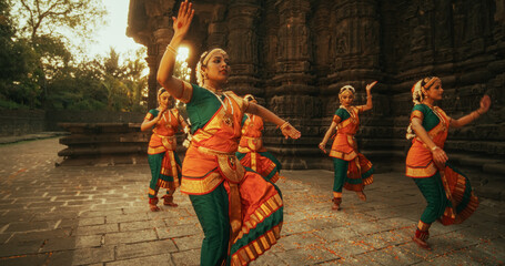 Dramatic Performance Done by an Indian Girls Practicing the Art of Bharatanatyam in an Ancient Temple. Expressive Young Females in Colourful Traditional Sari Dancing Folk Dance Choreography