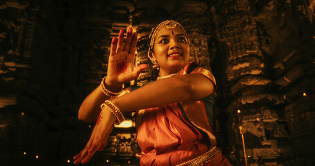 Portrait of an Active Indian Woman Engages in a Spellbinding Performance of Traditional Folk Dance...