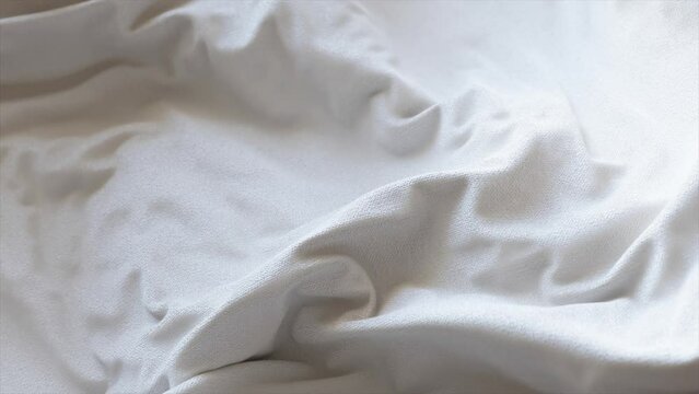 Realistic white fabric with gentle folds and creases capturing the texture and softness. 3D animation.