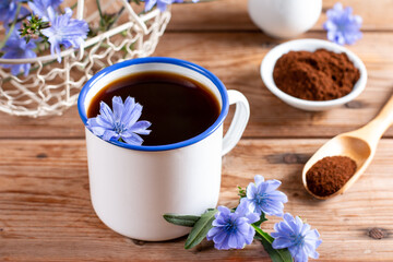Healthy chicory beverage and blue flowers on a table. Coffee substitute. - obrazy, fototapety, plakaty