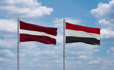Yemen and Latvia flags, country relationship concept