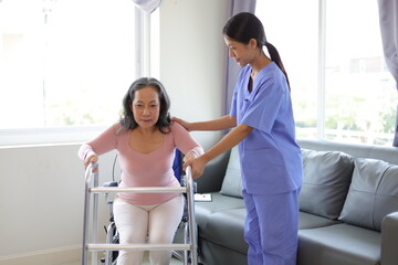 Female doctor help a senior patient who is doing physical therapy and is practicing walking with a walking stick. - obrazy, fototapety, plakaty