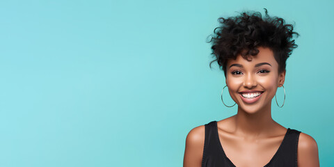 Smimilg young woman with dark skin and short groomed hair isolated on flat blue pastel background with copy space. Model for banner of cosmetic products, beauty salon and dentistry - obrazy, fototapety, plakaty