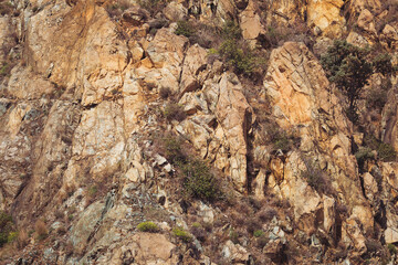 Texture cracked rock formation rock in the wild. Rocky cliff. Abstract Stone texture. Steep cliff of high mountain. Nature background, geological structure. Marble rocks in the wild. Detail Of Granite