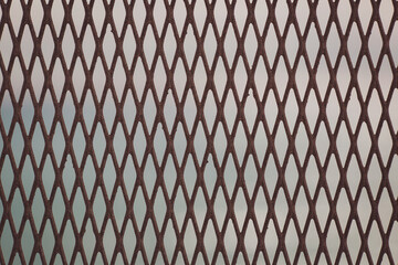 Naklejka premium Protective mesh on a blue sea background. iron fence on a blue sea and sky background. 
