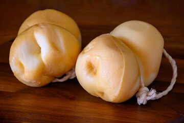 Italian semi hard handmade smoked scamorza cheese, from cow milk from Apulia or Calabria regions close up