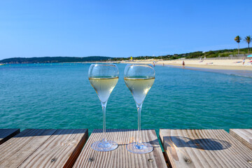 Summer time in Provence, two glasses of cold champagne cremant sparkling wine on famous Pampelonne...