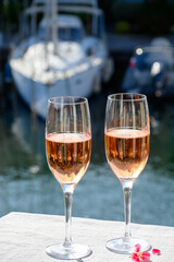 Summer party, drinking of French brut rose champagne sparkling wine in glasses in yacht harbour of Port Grimaud near Saint-Tropez, French Riviera vacation, France