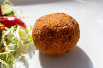 Tasty italian street food, deep fried aranchini rice balls with different filling