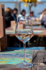 Drinking pinot grigio dry cold wine, served outdoor in beach cafe in North Holland, North sea sandy beach, the Netherlands