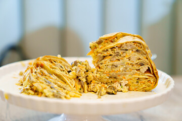 Pancake pie with meat and mushrooms. Traditional Russian kurnik pie. © andrey