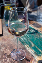 Drinking pinot grigio dry cold wine, served outdoor in beach cafe in North Holland, North sea sandy beach, the Netherlands