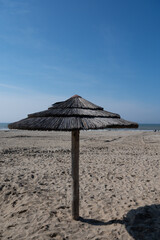 Beach holidays on sandy beach, waterfront relaxation with sun umbrella in Katwijk-on-zee, North sea, Netherlands