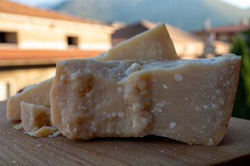 Traditional italian food - 36 months aged in caves Italian parmesan hard cheese from Parmigiano-Reggiano, Italy
