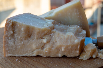 Traditional italian food - 36 months aged in caves Italian parmesan hard cheese from Parmigiano-Reggiano, Italy