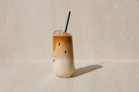 Close-up of a glass of iced coffee on a table in a cafe