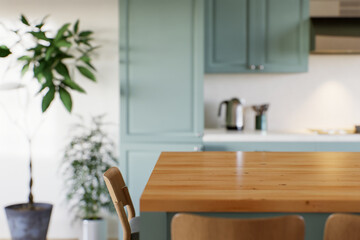 Obraz na płótnie Canvas Empty kitchen countertop with blurred kitchen background with appliances and utensils.