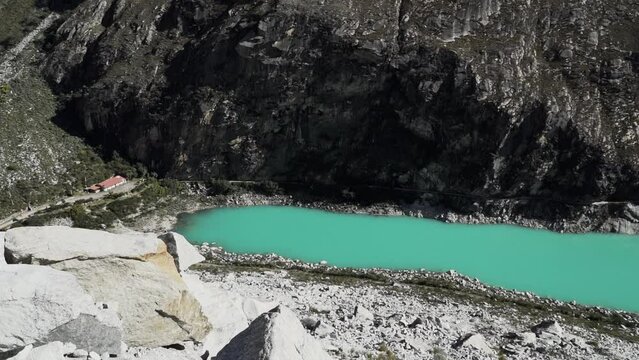 beautiful turquoise water of the lake at laguna paron lagoon in the high andes mountains of the cordillera blanca at huascaran, Peru, with snow covered mountain peaks on a bright sunny day.