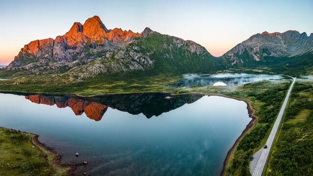 Aerial view of a road and mountain reflections in a lake, Svolvaer, Austvagoya, Lofoten, Nordland, Norway