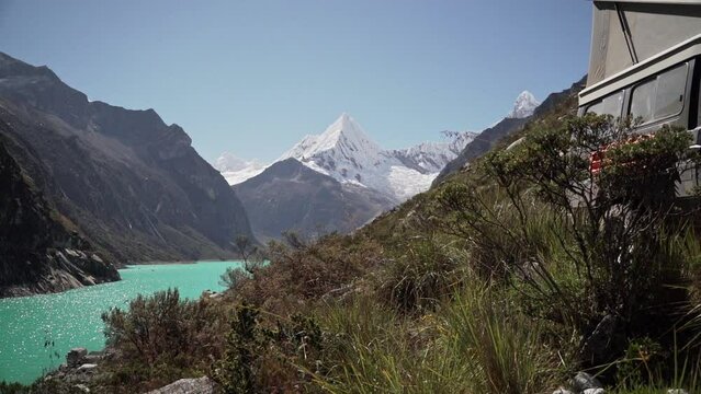 beautiful turquoise water of the lake at laguna paron lagoon in the high andes mountains of the cordillera blanca at huascaran, Peru, with snow covered mountain peaks on a bright sunny day.