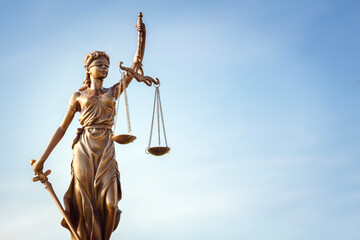 Legal law concept statue of Lady Justice with scales of justice with blue sky background - obrazy, fototapety, plakaty