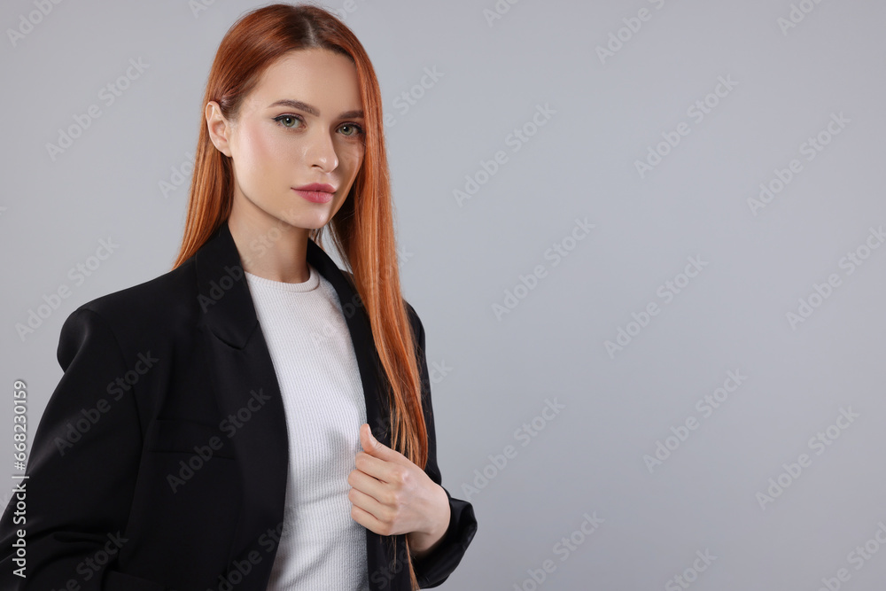 Wall mural Portrait of beautiful young woman on light gray background, space for text