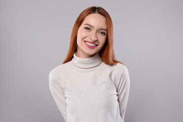 Portrait of beautiful young woman on light gray background
