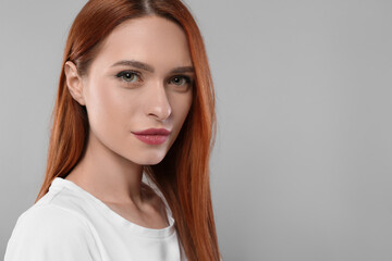 Fototapeta premium Portrait of beautiful young woman on light gray background, space for text
