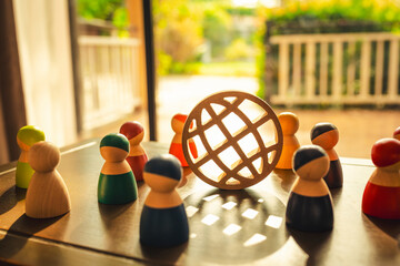 Wooden Globe icon and Multi-colored models stand together and discuss their work. Diverse group of...