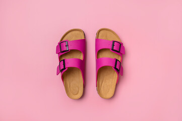 Trendy fashion footwear mockup. Leather pink magenta sandals birkenstocks on pink background top view flat lay. Unisex summer shoes, genuine leather flip flops with cork soles - obrazy, fototapety, plakaty