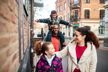 A cheerful family enjoys their vacation stroll in the city