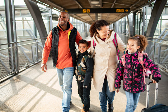 Joyful family embarks on a new journey at the train station