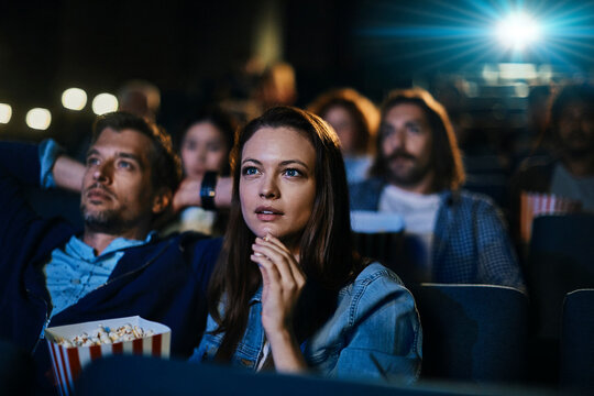 Engrossed couple watching a movie in a cinema