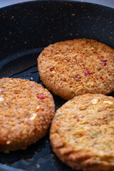 vegan burgers in teflon pan