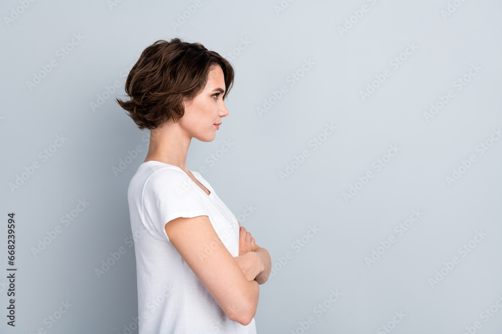 Canvas Prints Side profile photo of confident serious girl wear stylish t-shirt look empty space hold arms crossed isolated on gray color background