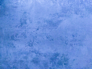 An old concrete wall with scuffs. Blue matte background.