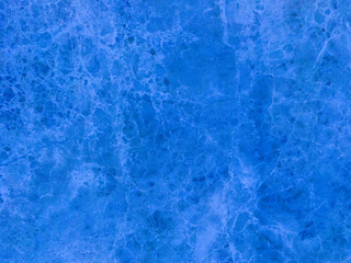 An old marble wall with scuffs and damage. Blue marble background.