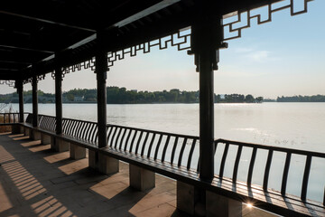 The long corridor by the lake in the park