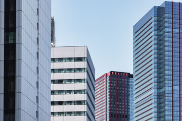 Fototapeta na wymiar high rise buildings with blue sky in Tokyo, Japan