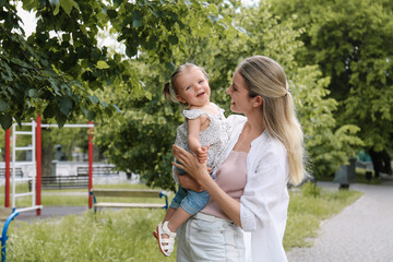 Fototapeta na wymiar Happy mother with her daughter spending time together in park. Space for text