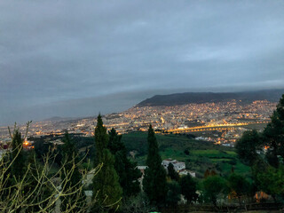 Mesmerizing and illuminating night view of the bustling city of Tetouan, capturing its stunning cityscape and illuminating skyline under the cloudy