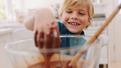 Happy, baking and hand of child in chocolate, cake or bowl recipe in kitchen for learning, development or cooking skills. Smile, boy and touching dessert, bake and curious, fun or laughing in Canada - Powered by Adobe