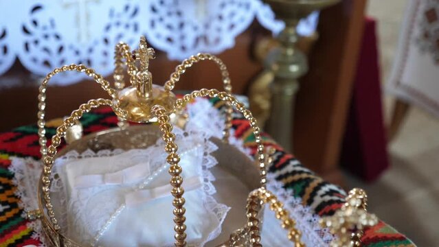 During the wedding ceremony, golden crowns are placed on the church throne.