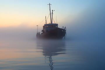 spectral ghost ship at foggy morning or evening. Neural network generated image. Not based on any actual person or scene.