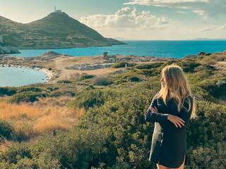 Girl against backdrop of lighthouse of ancient Greek city Knidos. Turkey.