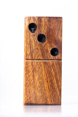 Domino tiles, handcrafted in wood, on white background, close-up