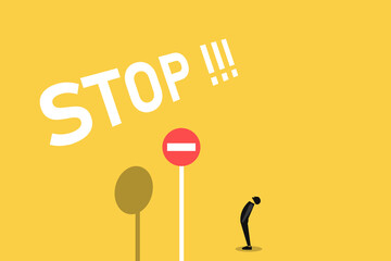 Businessman looking up stop sign, business concept in saying no, stop, or disagreement