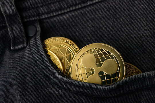 Criptomonedas y tecnolog&iacute;a.
XRP Ripple monedas de oro con la cartera, primer plano. acumulaci&oacute;n Bitcoin, el comercio de vender y comprar concepto.